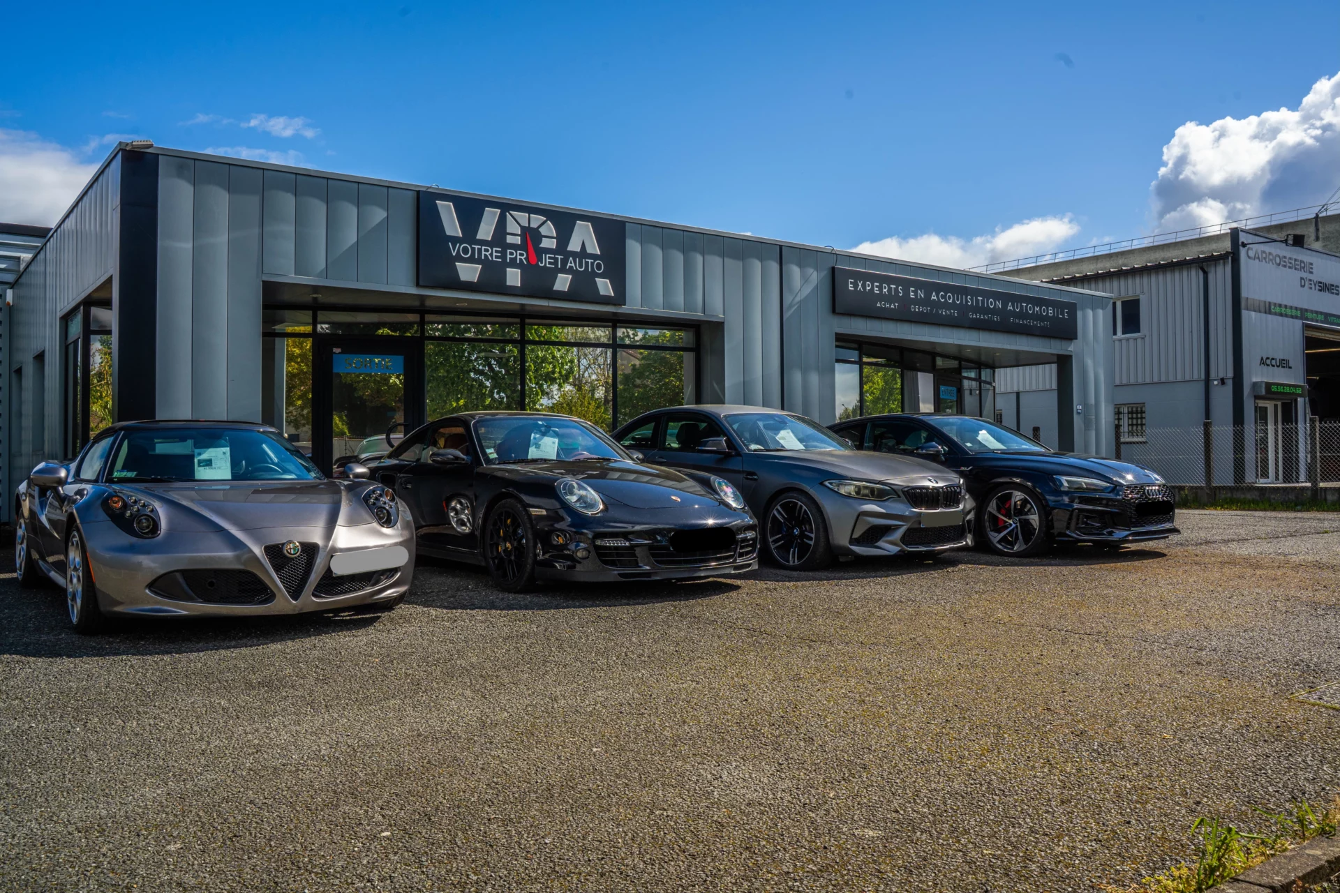 devanture VPA entrée du batiment de Votre Projet Auto avec des voitures devant
